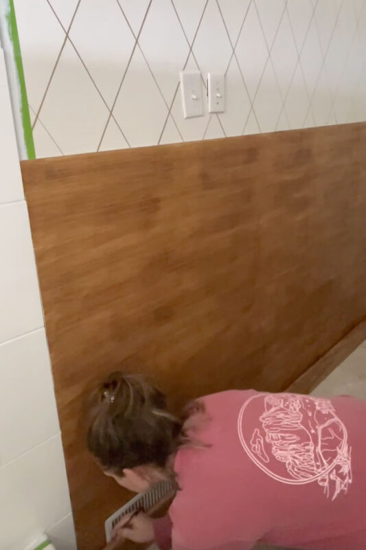 Marking and cutting a trim board for board and batten bathroom wall. 